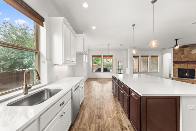 5701 Cherokee Draw Rd, Austin, TX 78738 - kitchen featuring a sink, stainless steel dishwasher, light wood-style floors, light countertops, and recessed lighting