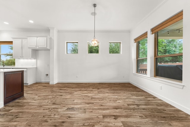 5701 Cherokee Draw Rd, Austin, TX 78738 - unfurnished dining area featuring crown molding, baseboards, wood finished floors, and recessed lighting