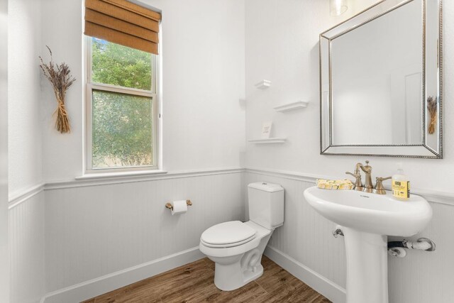 5701 Cherokee Draw Rd, Austin, TX 78738 - bathroom featuring wainscoting, toilet, baseboards, and wood finished floors