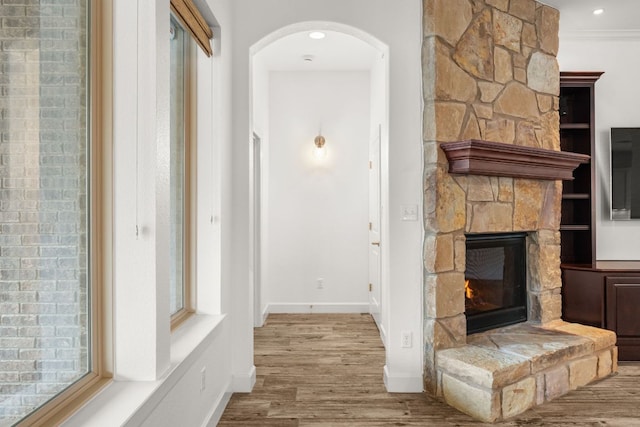 5701 Cherokee Draw Rd, Austin, TX 78738 - corridor with wood finished floors, arched walkways, baseboards, and crown molding