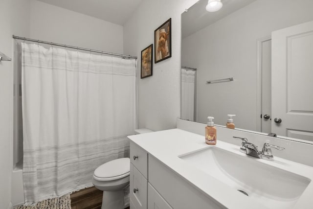 full bathroom featuring curtained shower, wood finished floors, toilet, and vanity