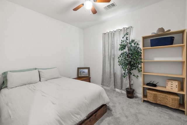 carpeted bedroom with visible vents and a ceiling fan