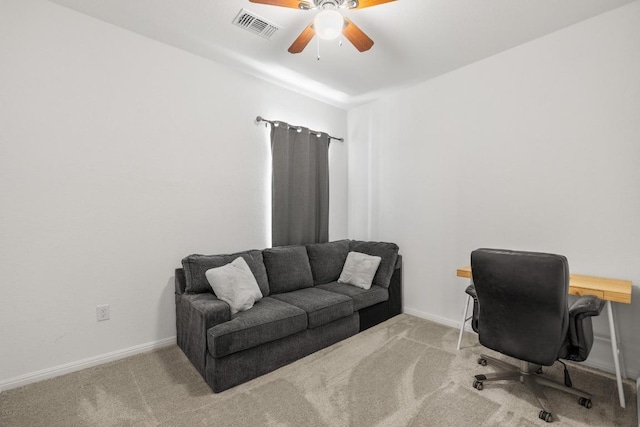 carpeted office space with a ceiling fan, baseboards, and visible vents