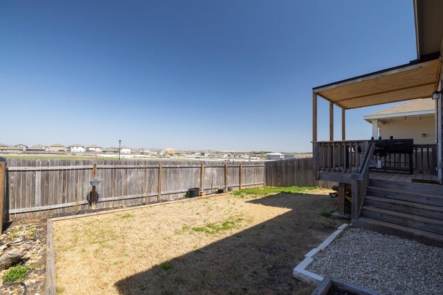 view of yard featuring a fenced backyard and a deck