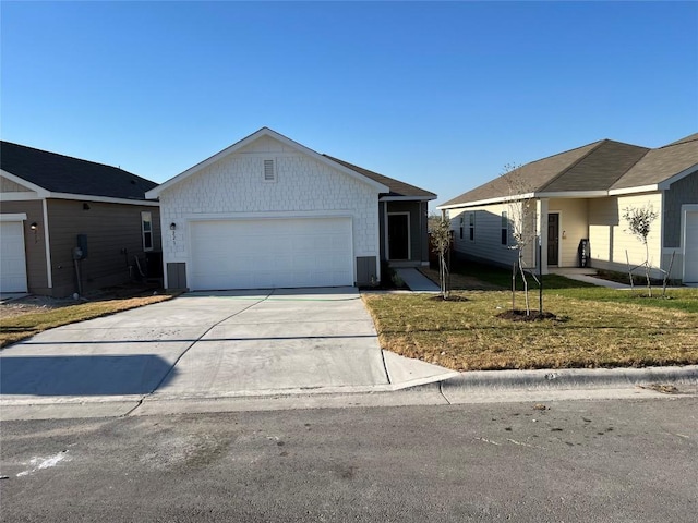 single story home featuring driveway, a garage, and a front lawn