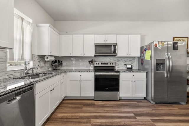 kitchen with white cabinets, a sink, stainless steel appliances, and dark wood-type flooring