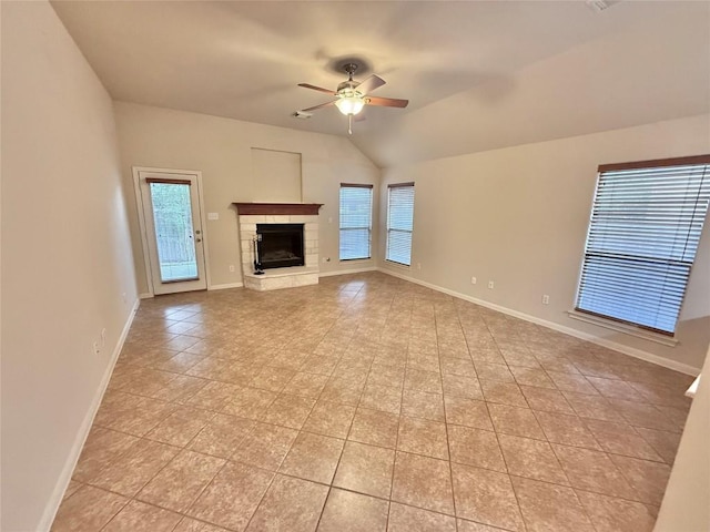unfurnished living room with plenty of natural light, a ceiling fan, baseboards, and light tile patterned floors