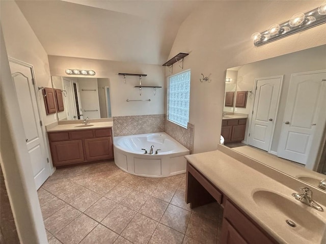 608 Pebblestone Walk Dr, Cedar Park, TX 78613 - bathroom featuring lofted ceiling, tile patterned flooring, a garden tub, and two vanities