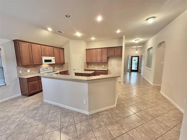 608 Pebblestone Walk Dr, Cedar Park, TX 78613 - kitchen featuring white appliances, light tile patterned flooring, decorative backsplash, a large island, and plenty of natural light