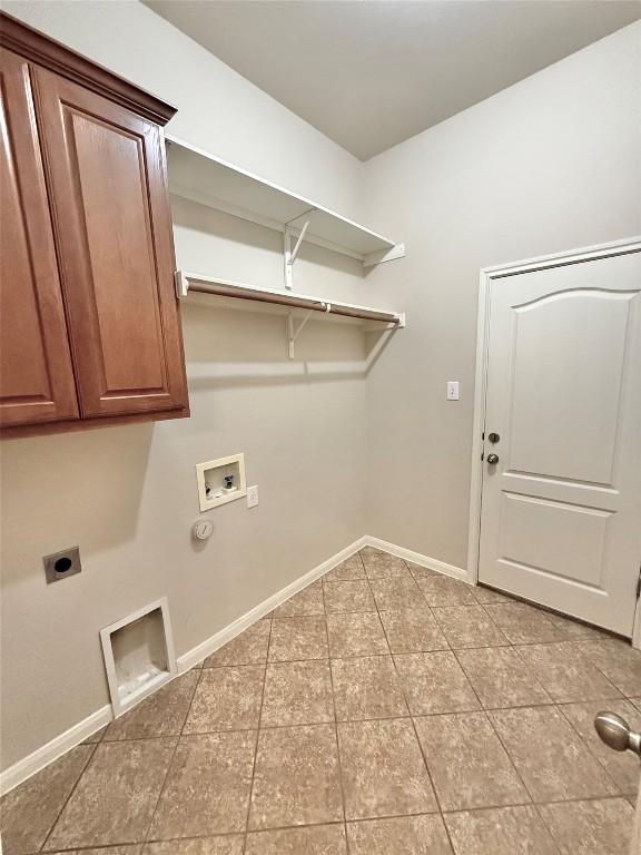 608 Pebblestone Walk Dr, Cedar Park, TX 78613 - laundry area with electric dryer hookup, washer hookup, cabinet space, and light tile patterned floors