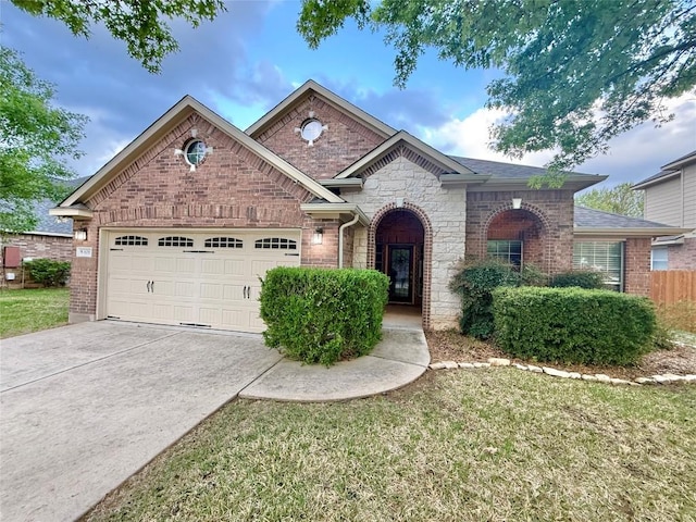 608 Pebblestone Walk Dr, Cedar Park, TX 78613 - view of front of home with driveway, an attached garage, stone siding, and brick siding