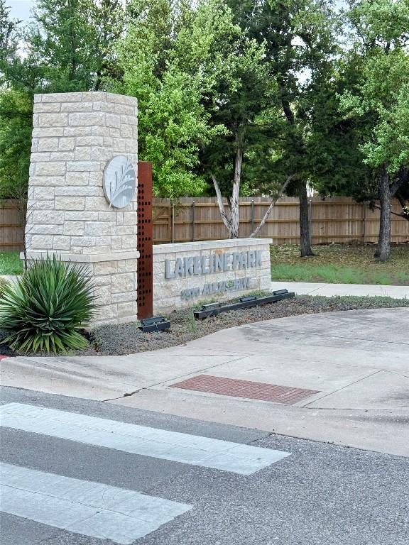 community sign featuring fence