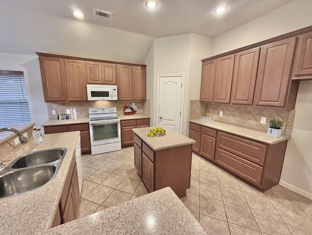 608 Pebblestone Walk Dr, Cedar Park, TX 78613 - kitchen with white appliances, tasteful backsplash, light tile patterned floors, vaulted ceiling, and recessed lighting