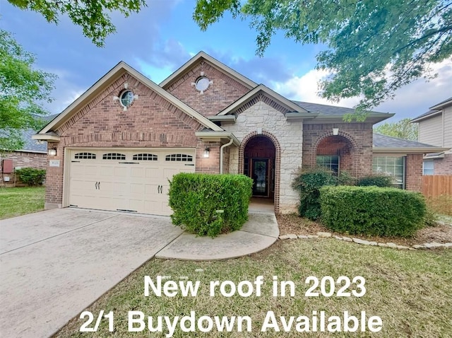 608 Pebblestone Walk Dr, Cedar Park, TX 78613 - view of front of house featuring an attached garage, driveway, stone siding, and brick siding