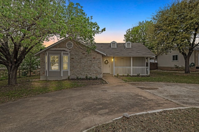 10418 Doc Holliday Trl, Austin, TX 78753 - view of front of house featuring a porch, board and batten siding, and stone siding