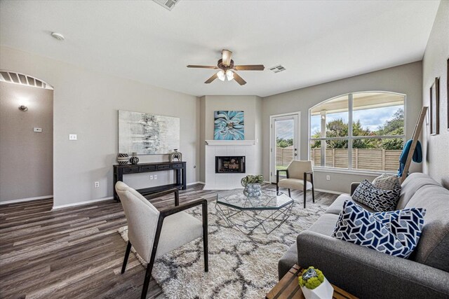 1606 Belvedere Pl, Round Rock, TX 78665 - living area with wood finished floors, a ceiling fan, baseboards, and a tile fireplace