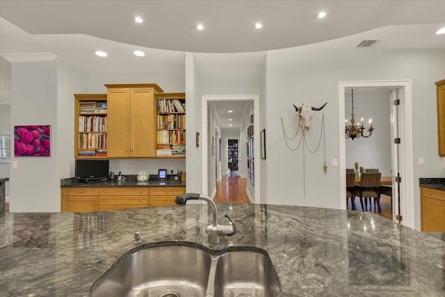 3208 Rain Dance Cv, Austin, TX 78746 - kitchen with open shelves, recessed lighting, dark stone countertops, and a chandelier
