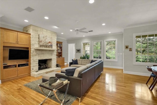 3208 Rain Dance Cv, Austin, TX 78746 - living area featuring ornamental molding, ceiling fan, a stone fireplace, light wood-style floors, and recessed lighting