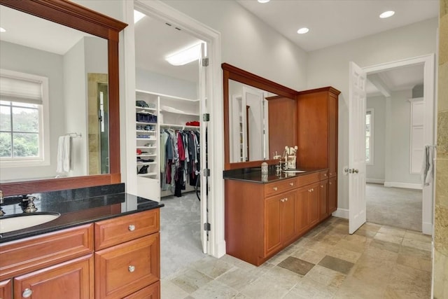 3208 Rain Dance Cv, Austin, TX 78746 - bathroom with two vanities, a walk in closet, and recessed lighting