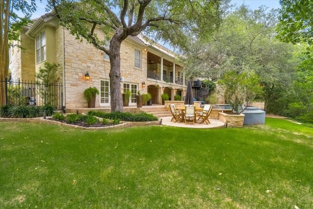 3208 Rain Dance Cv, Austin, TX 78746 - rear view of house featuring stone siding, a balcony, and a patio