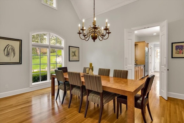 3208 Rain Dance Cv, Austin, TX 78746 - dining area featuring ornamental molding, plenty of natural light, a chandelier, light wood-style flooring, and lofted ceiling