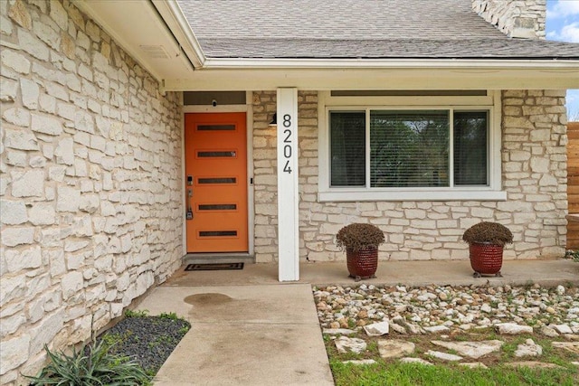 8204 Seminary Ridge Dr, Austin, TX 78745 - doorway to property with stone siding and a shingled roof