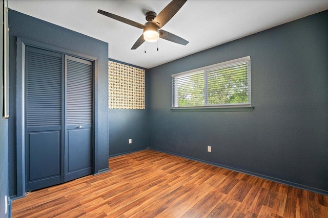 8204 Seminary Ridge Dr, Austin, TX 78745 - unfurnished bedroom with wood finished floors, a closet, and ceiling fan