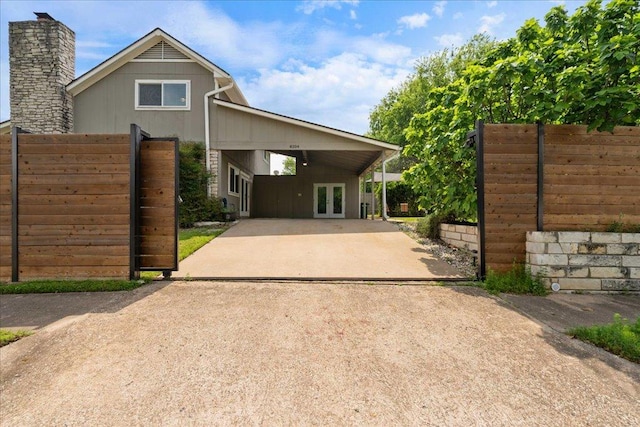 8204 Seminary Ridge Dr, Austin, TX 78745 - view of front of home with concrete driveway, french doors, and a carport