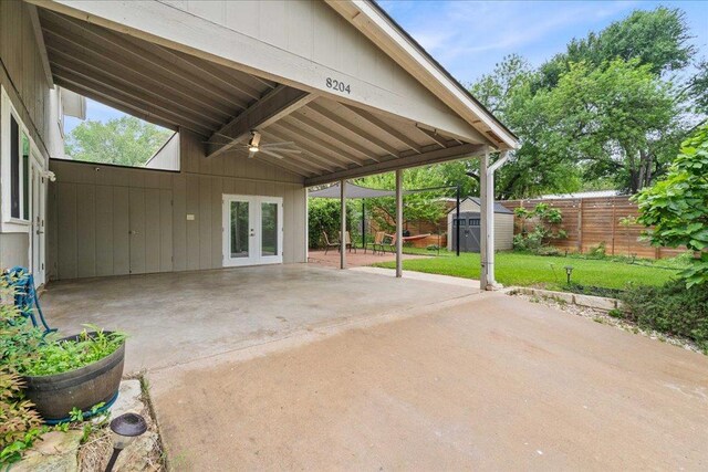 8204 Seminary Ridge Dr, Austin, TX 78745 - fenced backyard featuring french doors, a shed, a patio, ceiling fan, and an attached carport