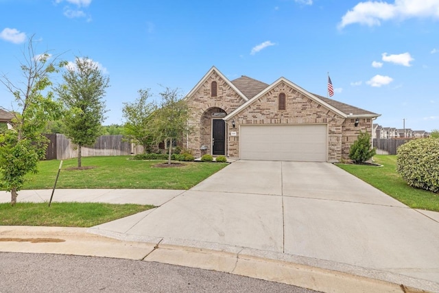 608 Roaming Dr, Hutto, TX 78634 - view of front of home with concrete driveway, an attached garage, and brick siding