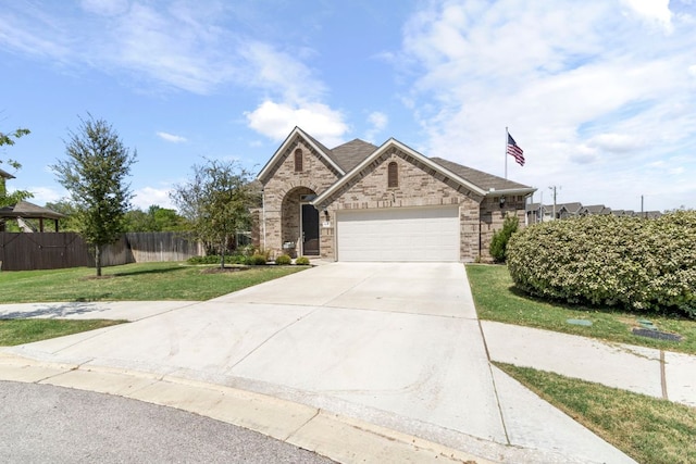 608 Roaming Dr, Hutto, TX 78634 - view of front of home with a garage and concrete driveway