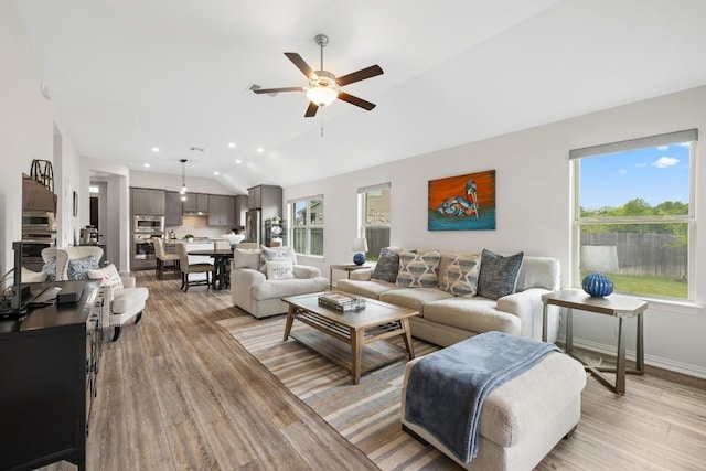 608 Roaming Dr, Hutto, TX 78634 - living area with lofted ceiling, light wood-type flooring, ceiling fan, healthy amount of natural light, and recessed lighting