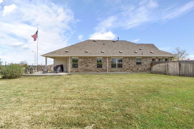608 Roaming Dr, Hutto, TX 78634 - rear view of property featuring a patio area, brick siding, and roof with shingles