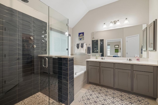 608 Roaming Dr, Hutto, TX 78634 - full bath featuring a shower stall, vaulted ceiling, a bath, and double vanity