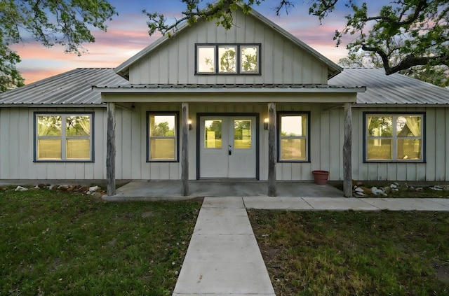 1022 County Road 111, Giddings, TX 78942 - view of front of property with metal roof, a front yard, and board and batten siding
