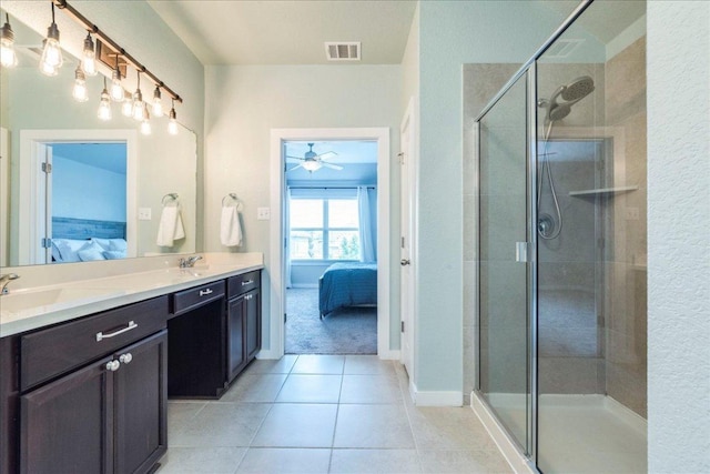 109 Pine Is, Leander, TX 78641 - full bathroom with connected bathroom, double vanity, a stall shower, tile patterned flooring, and ceiling fan