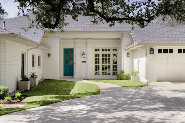 1904 Meadowbrook Dr, Austin, TX 78703 - view of front facade featuring brick siding, a garage, a shingled roof, and driveway