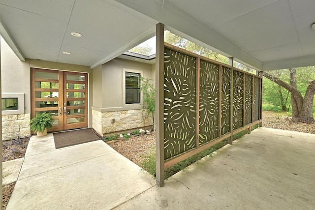 9206 Chisholm Ln, Austin, TX 78748 - view of exterior entry featuring stone siding, french doors, and stucco siding