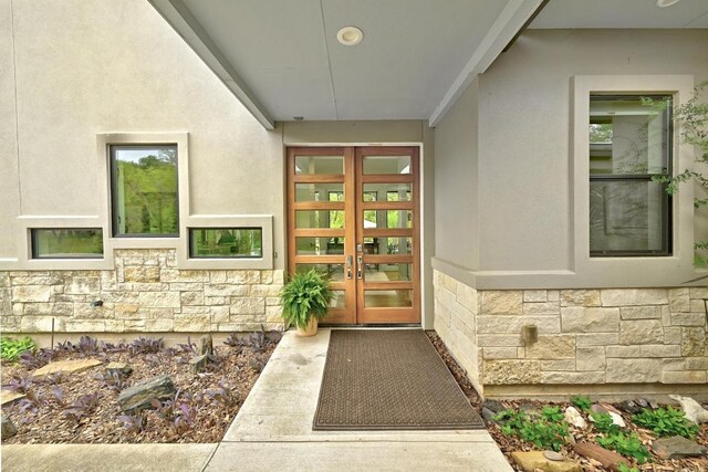 9206 Chisholm Ln, Austin, TX 78748 - view of exterior entry featuring stone siding, french doors, and stucco siding