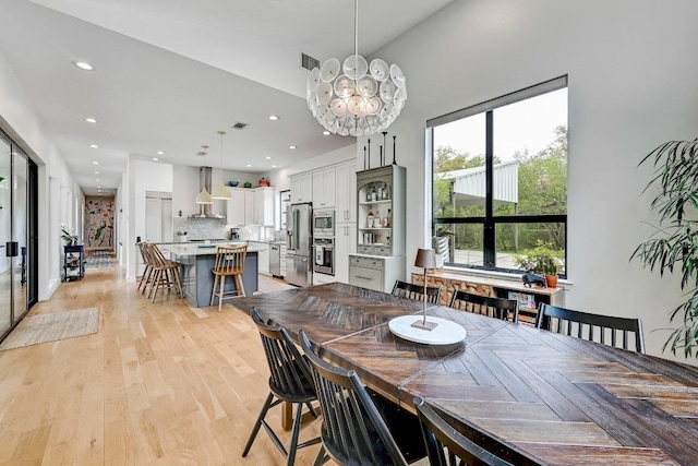 9206 Chisholm Ln, Austin, TX 78748 - dining area with a chandelier, recessed lighting, and light wood-style flooring