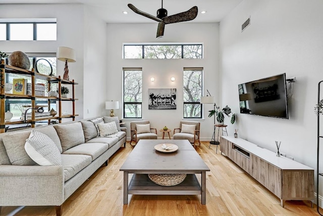 9206 Chisholm Ln, Austin, TX 78748 - living room featuring a towering ceiling, light wood-type flooring, ceiling fan, and recessed lighting