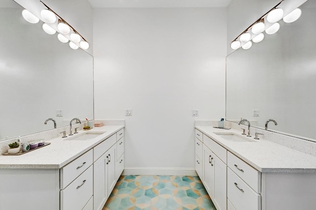 9206 Chisholm Ln, Austin, TX 78748 - bathroom featuring two vanities and baseboards
