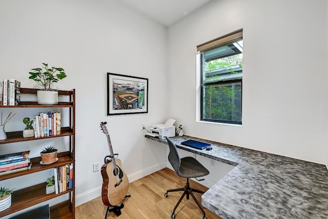 9206 Chisholm Ln, Austin, TX 78748 - office featuring light wood-type flooring, baseboards, and built in desk