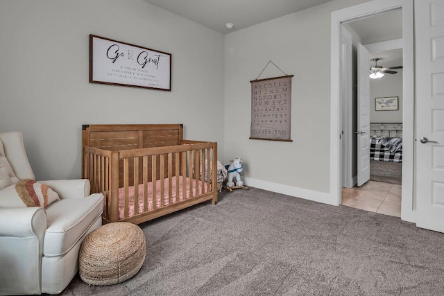 109 Spice Bush Spgs, Leander, TX 78641 - carpeted bedroom featuring baseboards, a crib, and tile patterned flooring