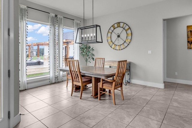 109 Spice Bush Spgs, Leander, TX 78641 - dining area featuring light tile patterned floors, a chandelier, and baseboards