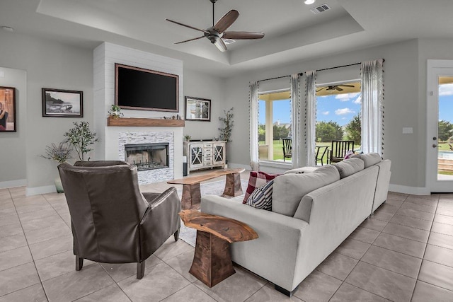 109 Spice Bush Spgs, Leander, TX 78641 - living area with a tray ceiling, ceiling fan, baseboards, and light tile patterned floors