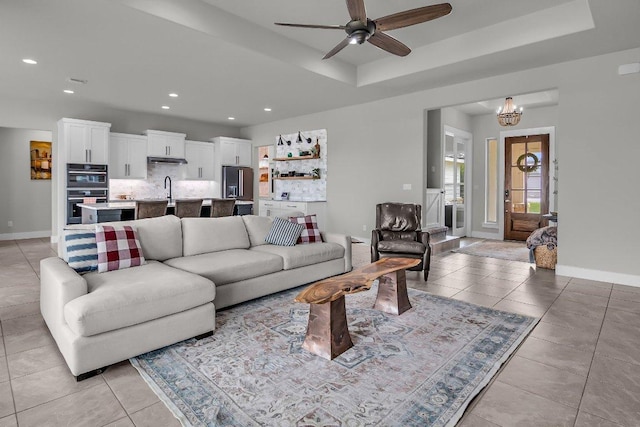109 Spice Bush Spgs, Leander, TX 78641 - living area featuring light tile patterned floors, ceiling fan, recessed lighting, a tray ceiling, and baseboards