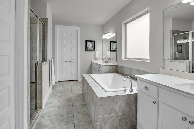109 Spice Bush Spgs, Leander, TX 78641 - full bathroom with a shower stall, two vanities, and a garden tub