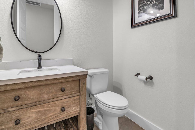 109 Spice Bush Spgs, Leander, TX 78641 - bathroom featuring toilet, vanity, baseboards, and a textured wall
