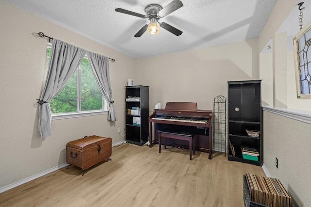 8410 Glen Canyon Dr, Round Rock, TX 78681 - sitting room with wood finished floors, a textured ceiling, and a ceiling fan